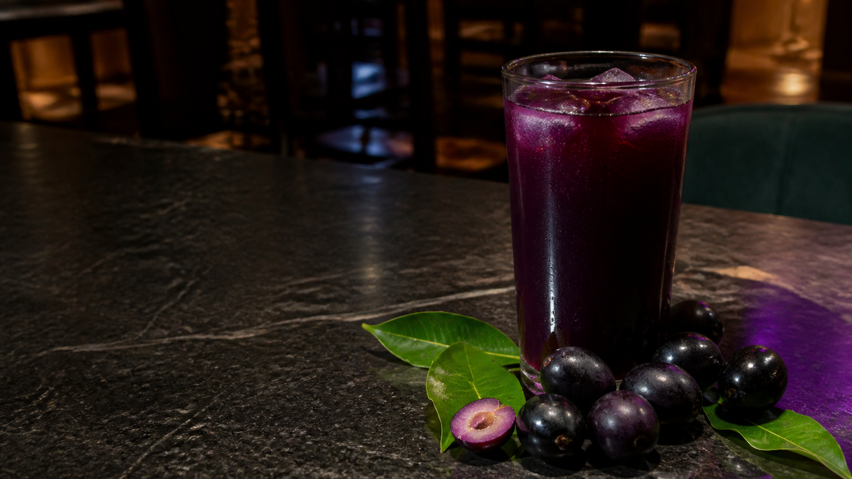 A glass of Jamun juice with Java plum fruit